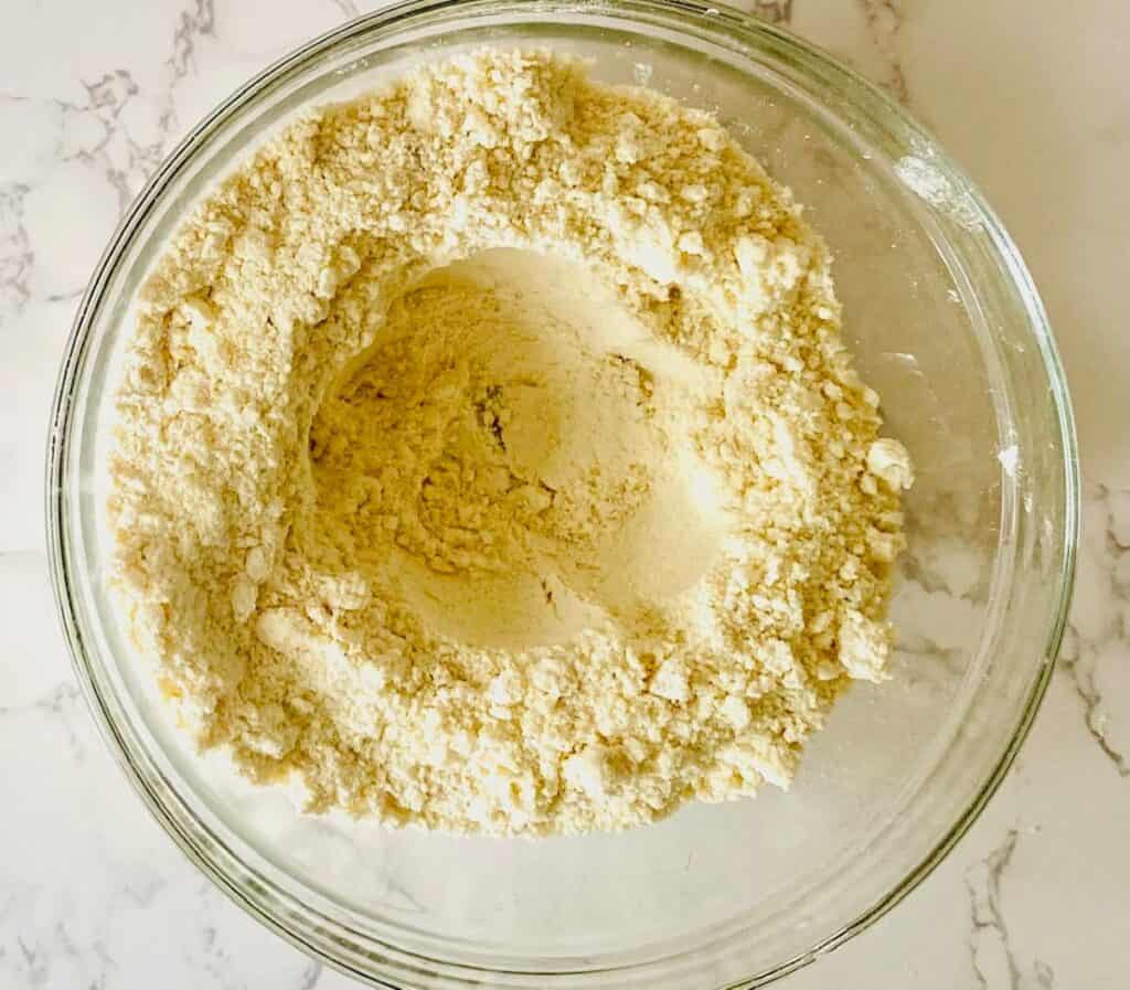 Flour with a well in the centre in a bowl