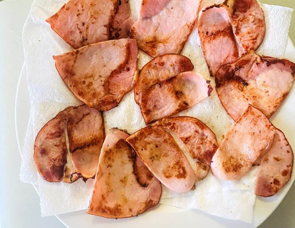 Mini BLT sliders with green goddess dressing cooked bacon sitting on paper towel