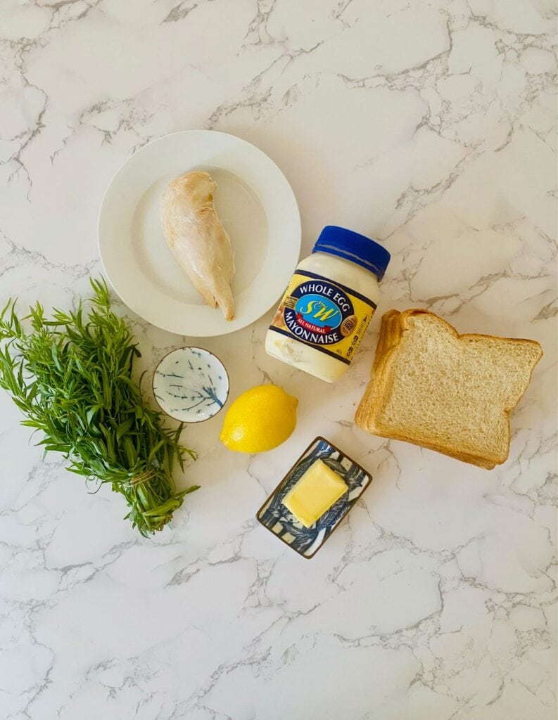 Ingredients for chicken finger sandwiches sit on a marble bench