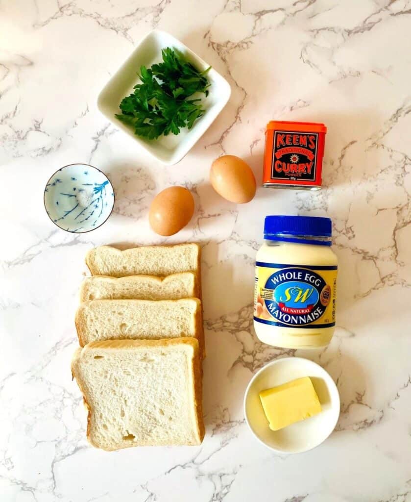 A flat lay of curried egg sandwich ingredients