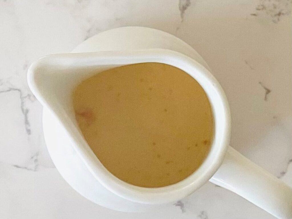 A jug with milk and egg yolk for Smoked salmon pikelets