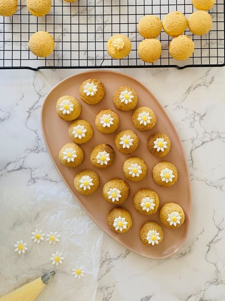 Daisy Choux Puffs sit on a pink platter