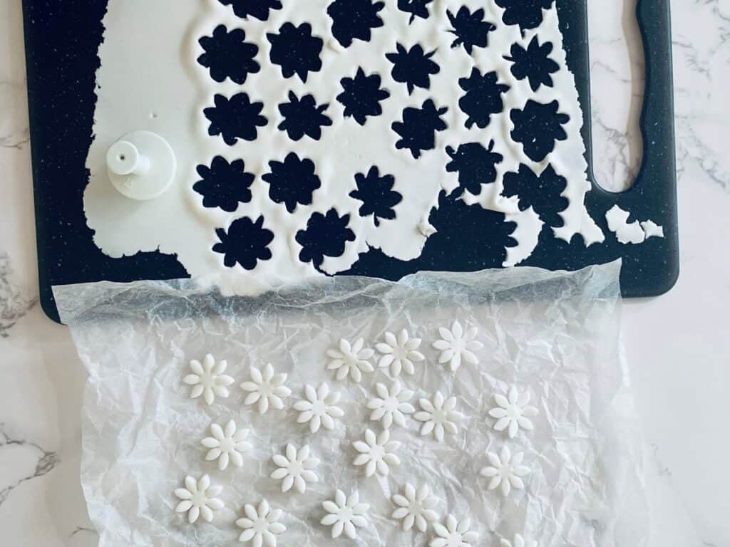 fondant daisies cut out on a board