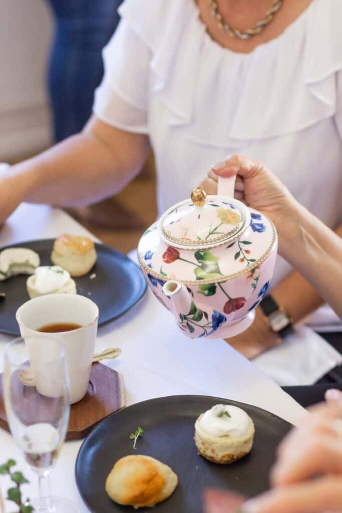 How to make tea a teapot and cup being poured by friends