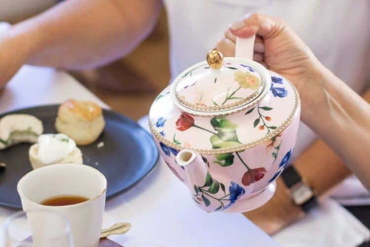How to make tea a teapot and cup being poured by friends