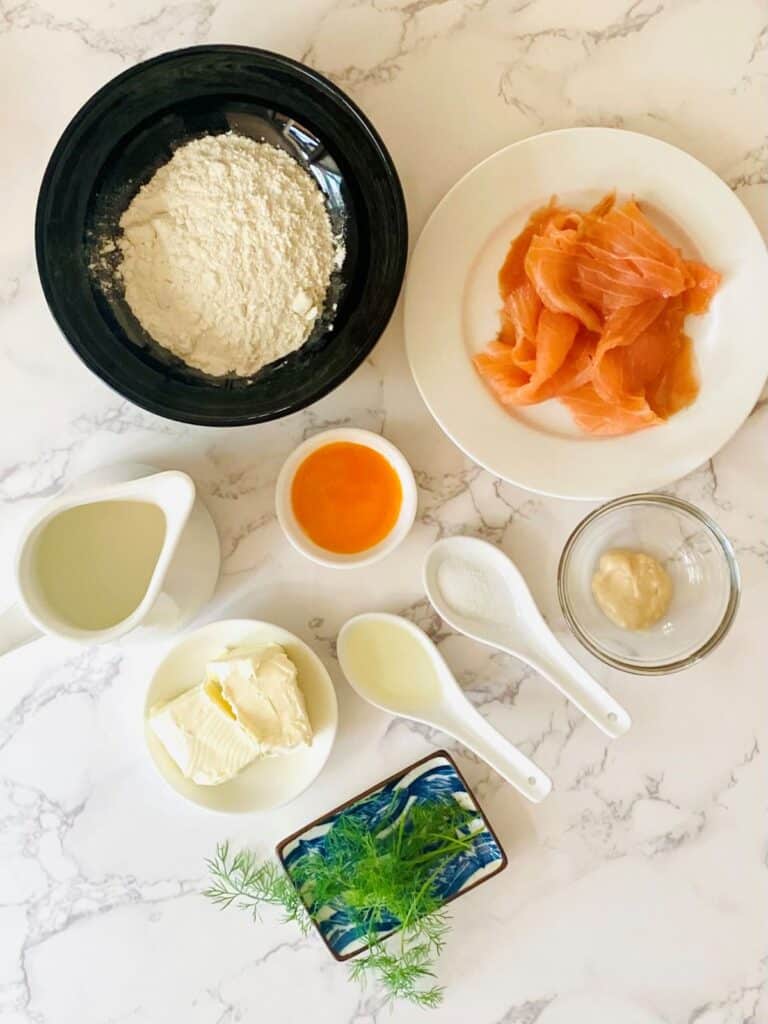 Ingredients for Smoked Salmon Pikelets sit on a marble bench