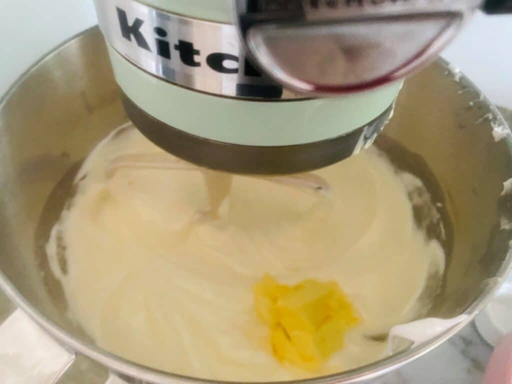 Swiss meringue buttercream adding the butter