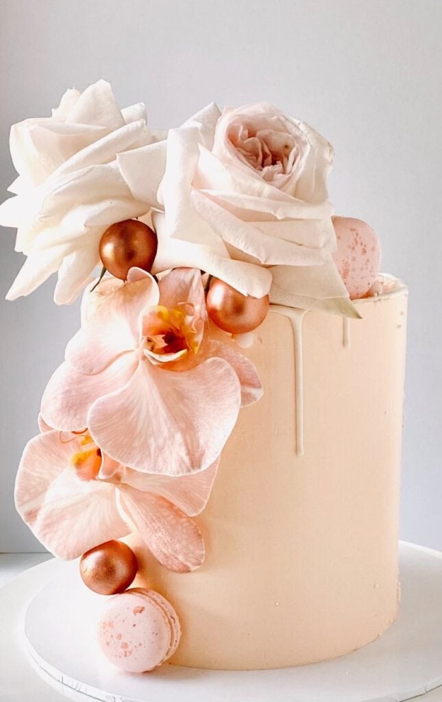 Pale pink cake with roses covered in Swiss meringue buttercream