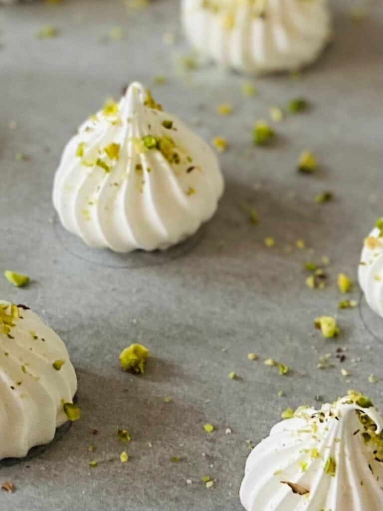 Piped meringues topped with pistachios 