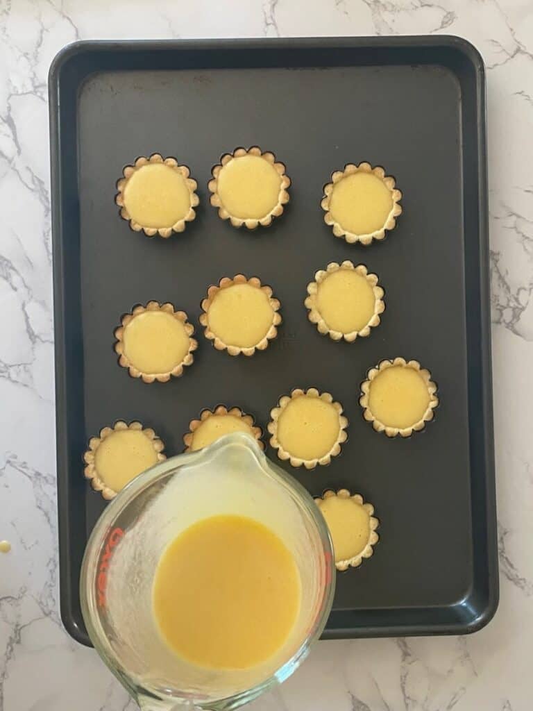Fill the shells with the lemon mixture for Lemon Tartlets with Pistachio Meringues recipe