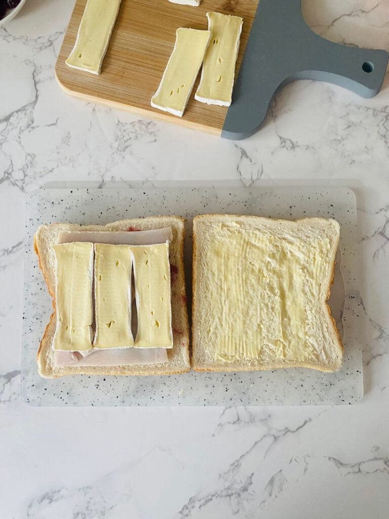 Turkey, cranberry & brie finger sandwiches preparation - add the brie