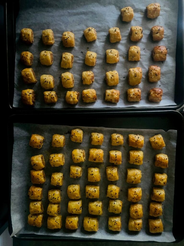 Tiny sausage rolls on a tray
