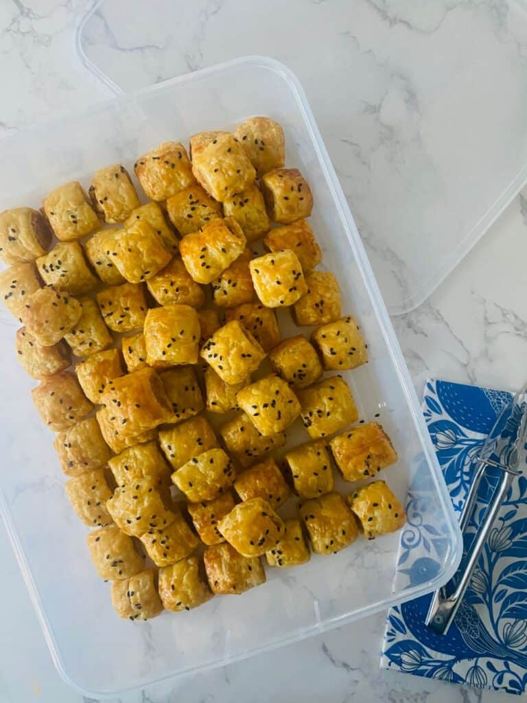 Tiny sausage rolls in a sealable container