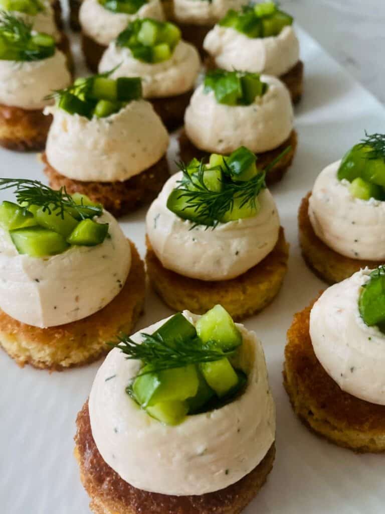 Salmon cucumber brioche bites on a platter