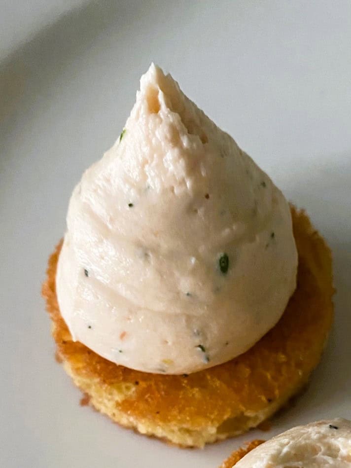 Salmon cucumber brioche bites mixture piped on rounds