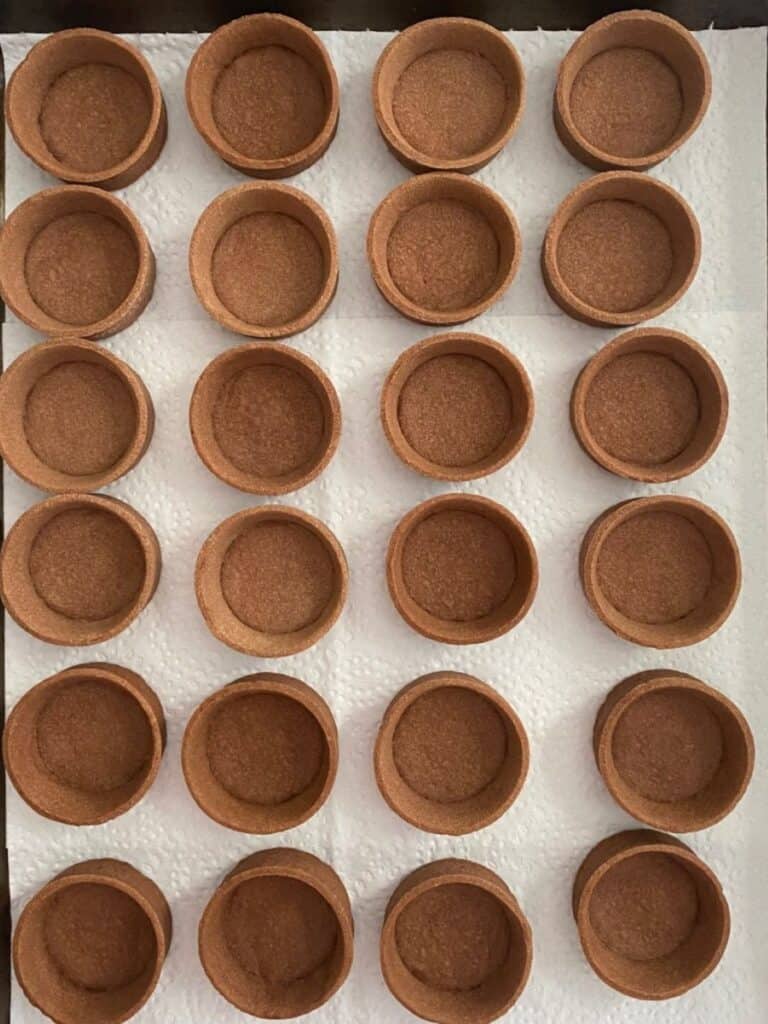 chocolate tartlet shells on a tray