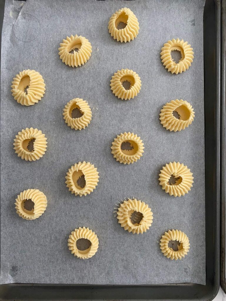 Melting moment rings piped on a tray