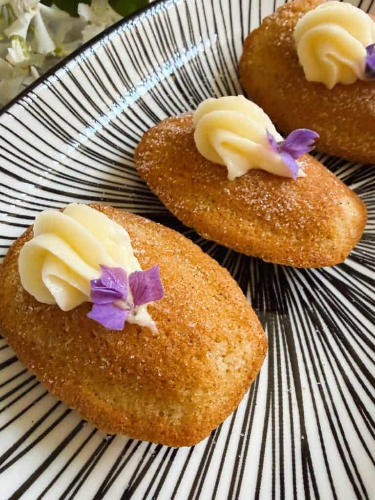 Three cinnamon roll madeleines on a plate