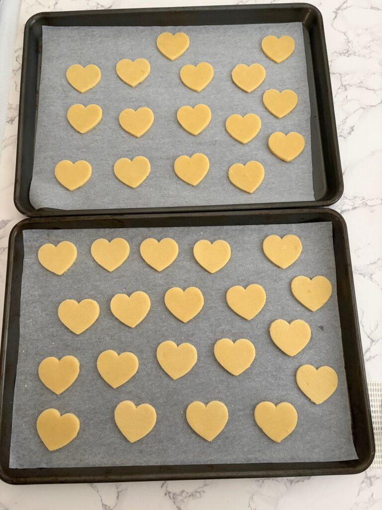 Heart cookies cut out on a tray