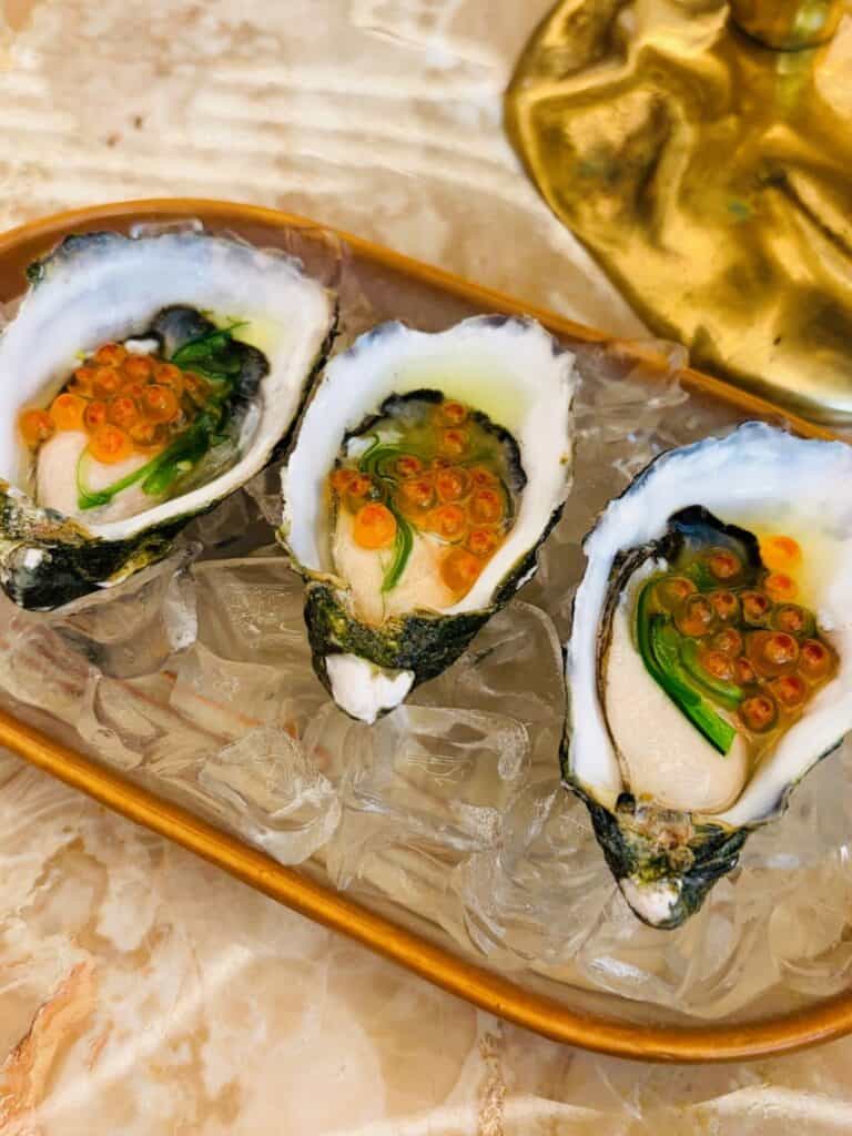 Oysters on a plate with Salmon roe and seaweed