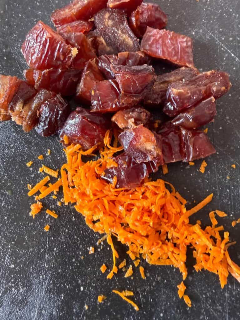 Medjool dates and orange zest on a board