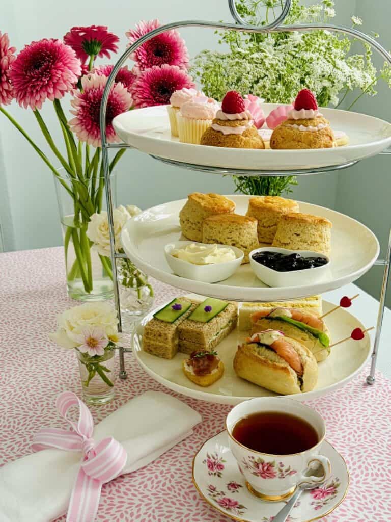 Smoked salmon mini rolls on a tiered stand with other delights