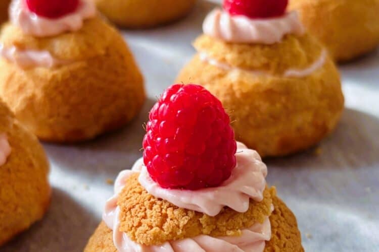 Raspberry cheesecake choux puffs in a row