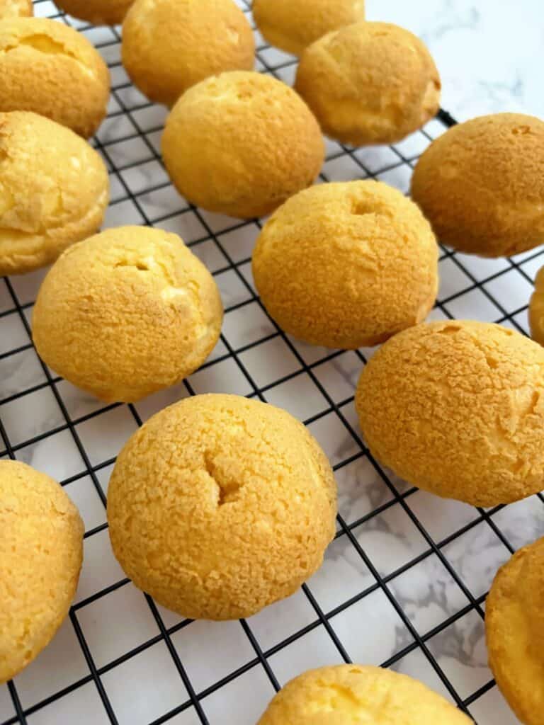 choux puffs on a cooling rack