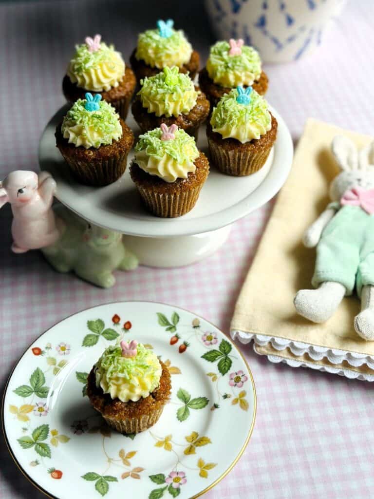 Easter-themed Mini Carrot Cakes on a plate with an Easter bunny and yellow napkin