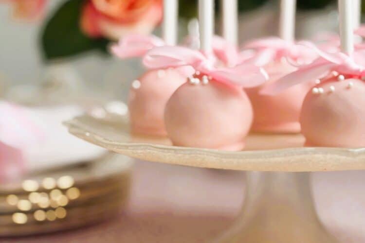 raspberry and coconut truffle pops on a stand