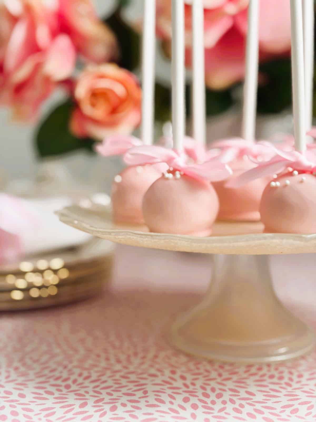 raspberry and coconut truffle pops on a stand