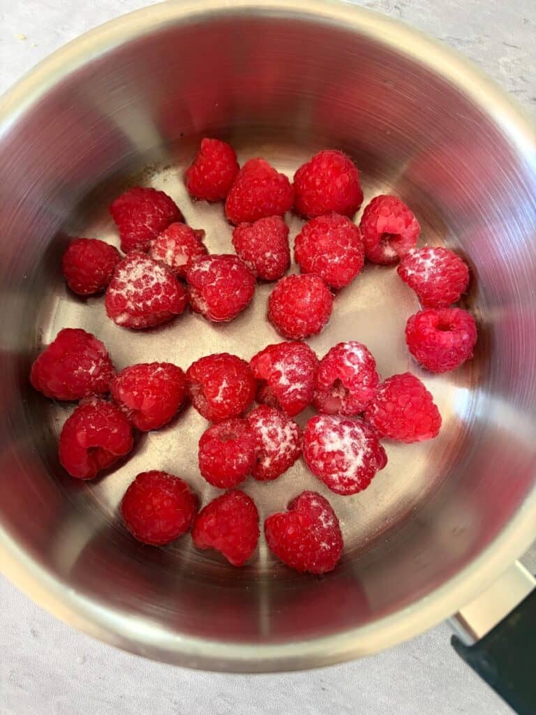 Rasperries, sugar and water in a saucepan