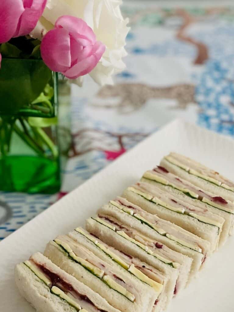 Turkey, cranberry and brie finger sandwiches on a tray