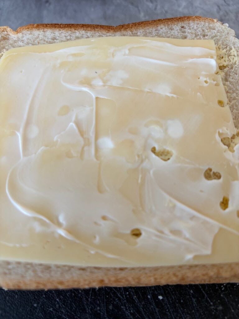 Add Swiss cheese and mayonnaise to the bread
