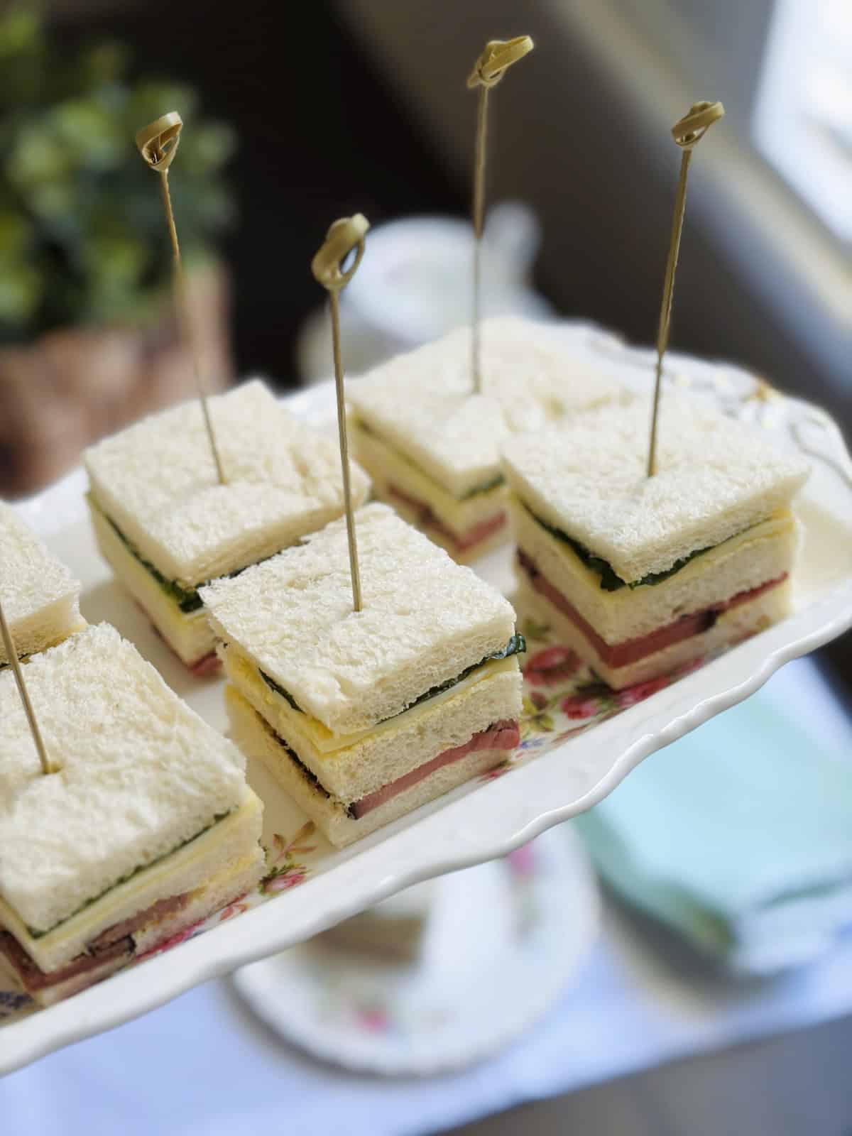 Roast beef and horseradish sandwich squares on a platter