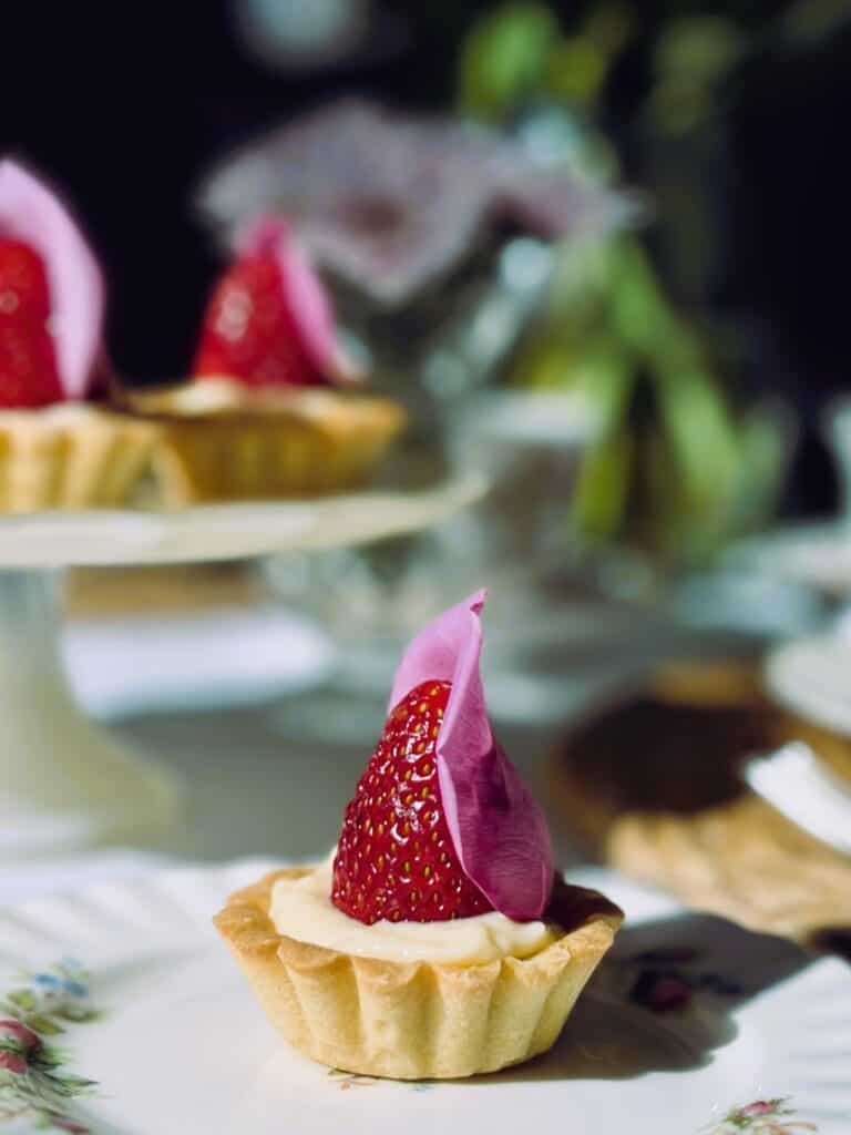 Little strawberry rose tartlets on a cake stand 
